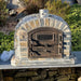 Lisboa Premium Pizza Oven fully installed in a rustic outdoor stone kitchen setup.