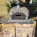 Rustic Pizzaioli Premium Pizza Oven by Authentic Pizza Ovens installed in a custom outdoor stone kitchen.